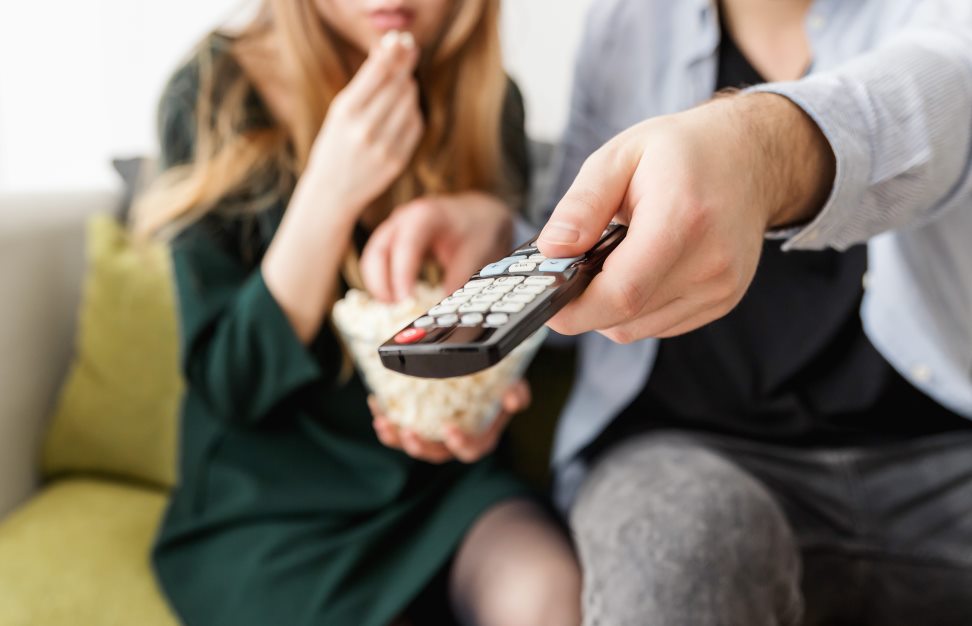 man and wife watching tv